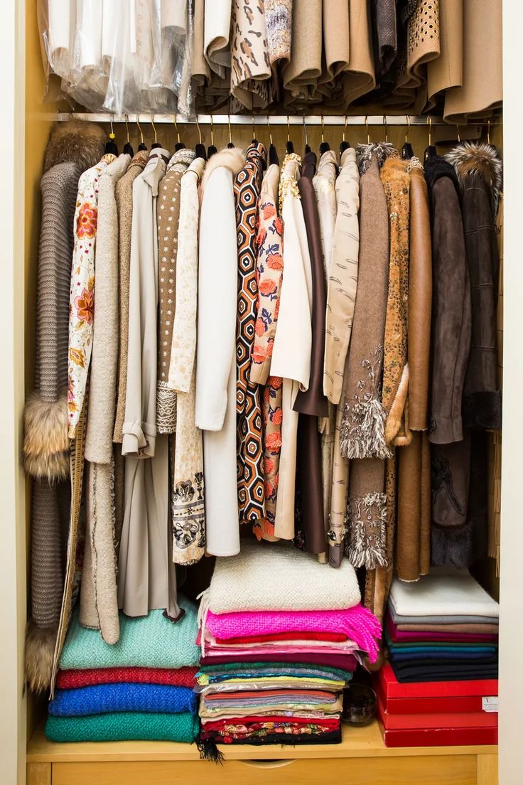 a closet filled with lots of clothes and scarves