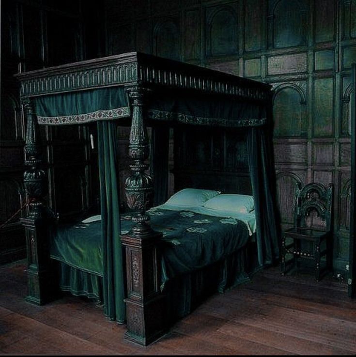 an old fashioned bed in a room with wood paneled walls and wooden flooring