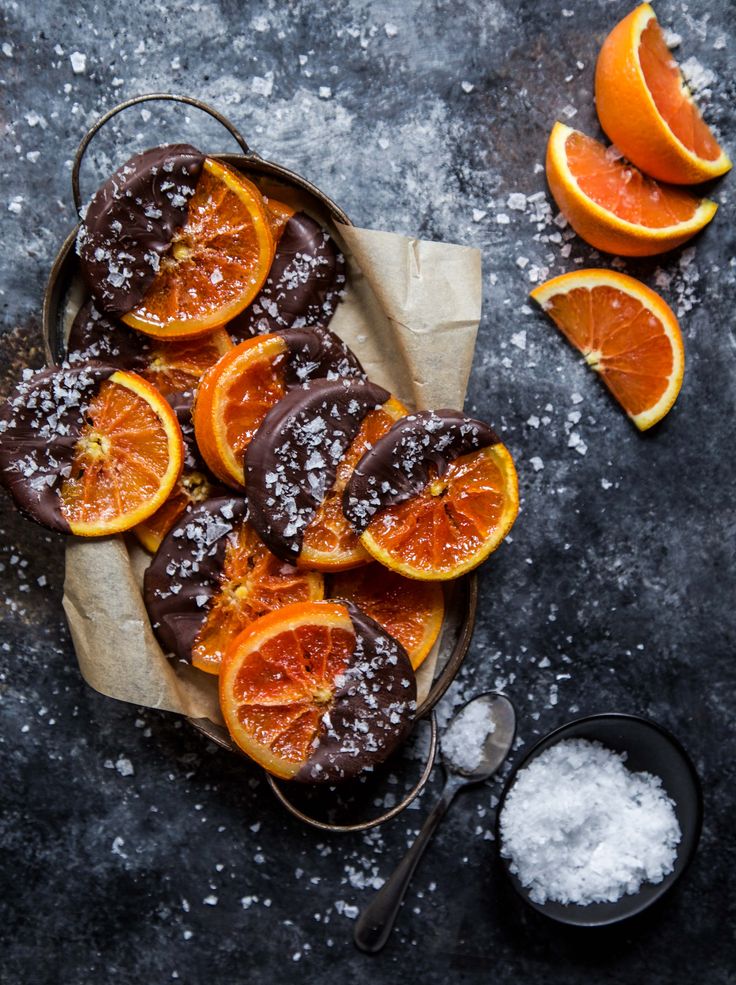 some oranges and sugar are on a table