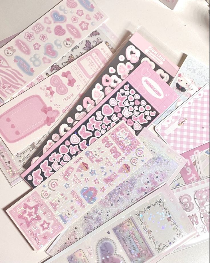 some pink and white stickers on a table