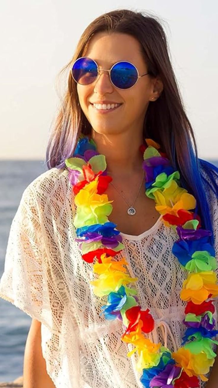 a woman wearing sunglasses and a rainbow lei