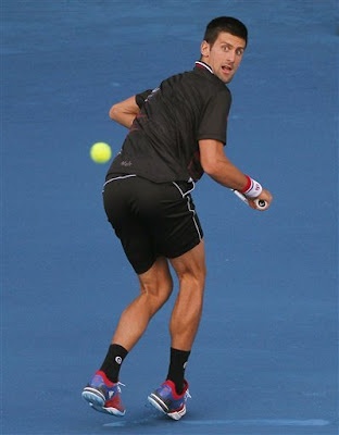 a male tennis player in action on the court