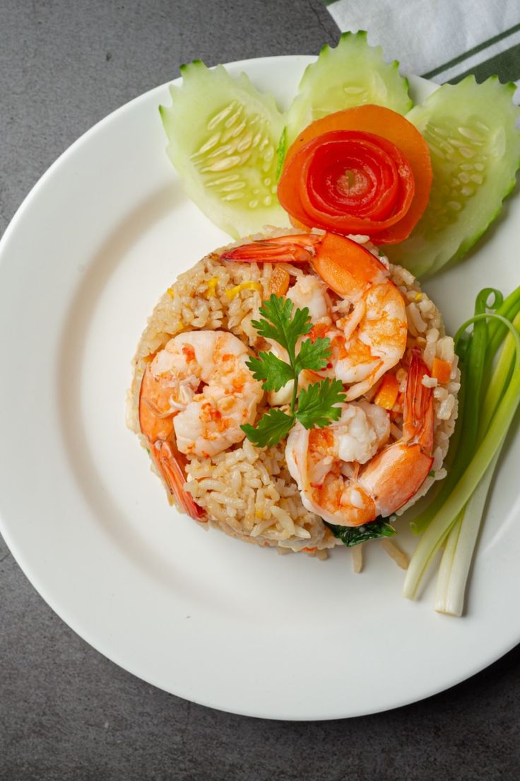 a white plate topped with rice and shrimp