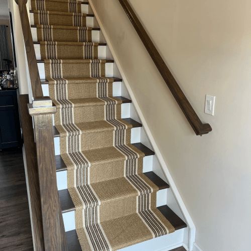 a staircase with carpeted steps leading up to the second floor