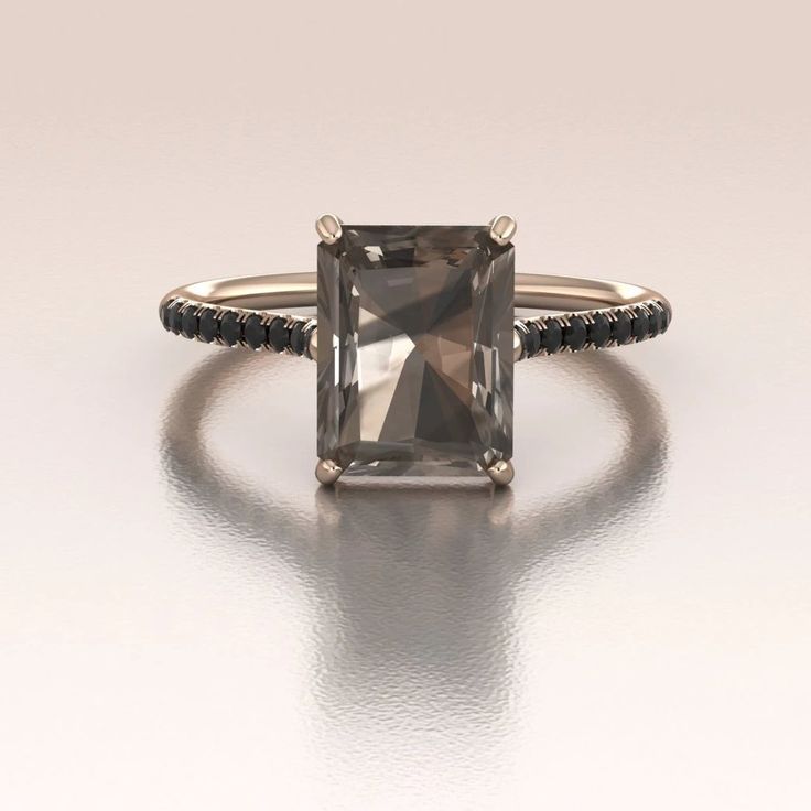 This is our new Smoky Quartz Ring made in 14K Rose Gold. The center stone is about 2.80ct (9x7mm) brown Smoky Quartz (color may vary due to the nature of the stone) set in a four prong solitaire setting. There are genuine Black Diamonds along the cathedral style shank set micro pave raising elegantly towards the center stone with total weight about 0.15ct. This ring can be perfect for an alternative engagement ring. Modern Bride Jewelry, Smoky Quartz Engagement Ring, Wedding Rings Emerald Cut, Black Diamond Jewelry, Quartz Engagement Ring, Black Engagement Ring, Smoky Quartz Ring, Quartz Color, Emerald Cut Rings