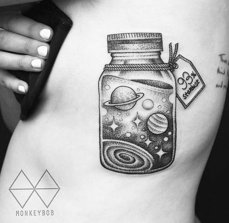 a woman's stomach has a jar with planets in it and a tag on the side