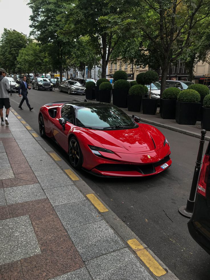 a red sports car is parked on the street