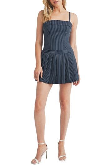 A sharply pleated skirt overlay adds to the preppy charm of this leggy romper covered in polished pinstripes. 25 1/2" center front length; 1" inseam; 26" leg opening (size Medium) Hidden side-zip closure Square neck Adjustable straps Lined 91% polyester, 9% rayon Hand wash, line dry Imported Fitted Striped Skort With Pleated Skirt, Fitted Mini Length Skort With Pleated Waist, Summer Pleated Tennis Dress, Spring Pleated Short Tennis Dress, Chic Fitted Striped Skort, Chic Striped Fitted Skort, Striped Mini Skort For Spring, Spring Tennis Dress With Pleated Hem, Fitted Pleated Hem Preppy Skort