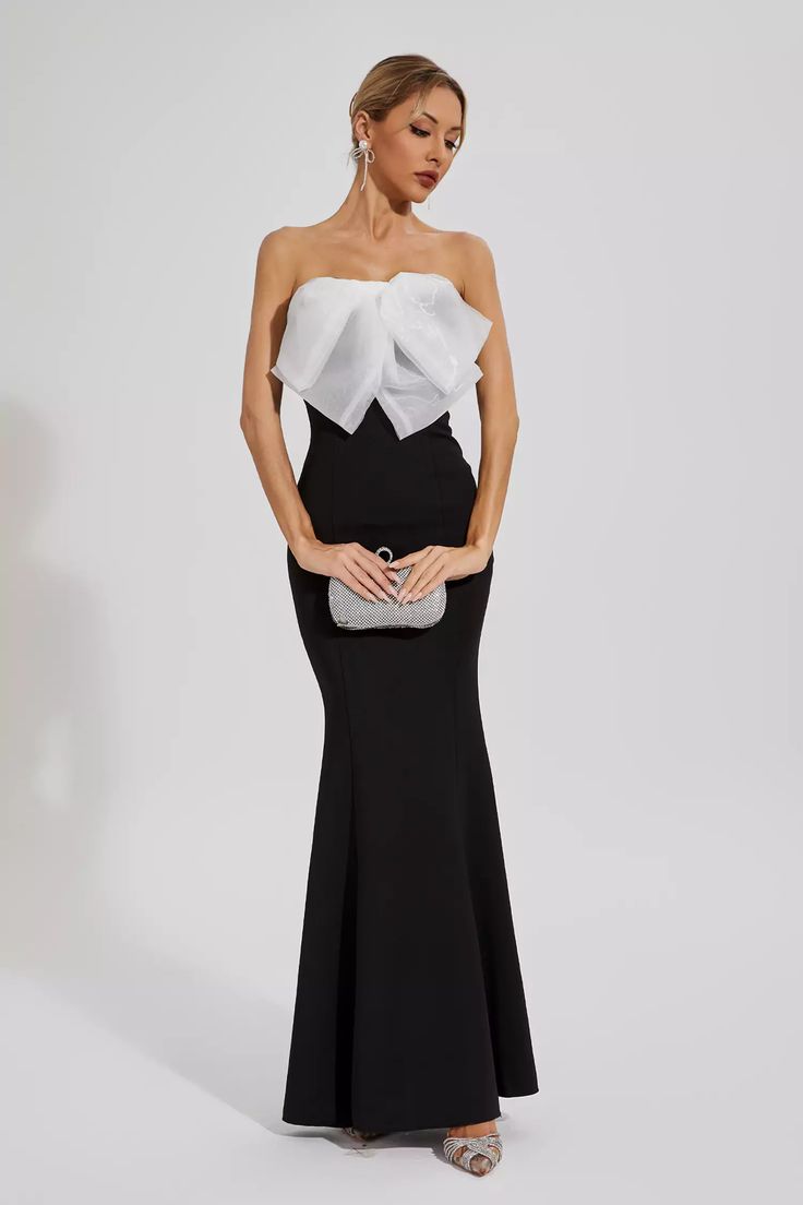 Elevate your evening glamour with the elegant Paisleigh Black White-bow Mermaid Dress. This captivating gown features a figure-flattering strapless bodice and a mesmerizing mermaid silhouette. Perfect for formal events and special occasions, this dress combines sophistication and allure with its eye-catching black and white bow detail.  Length: Approx 142cm Materials: Polyester Gentle Dry Clean Only  The model is 5 ft 7 and wears size S  Color may vary due to lighting on images. The product imag Silver Sequin Top, Glitter Wedding Dress, Bandage Midi Dress, Floral Shirt Dress, Mermaid Silhouette, Puff Sleeve Dresses, Maxi Knit Dress, White Bow, Mermaid Dress