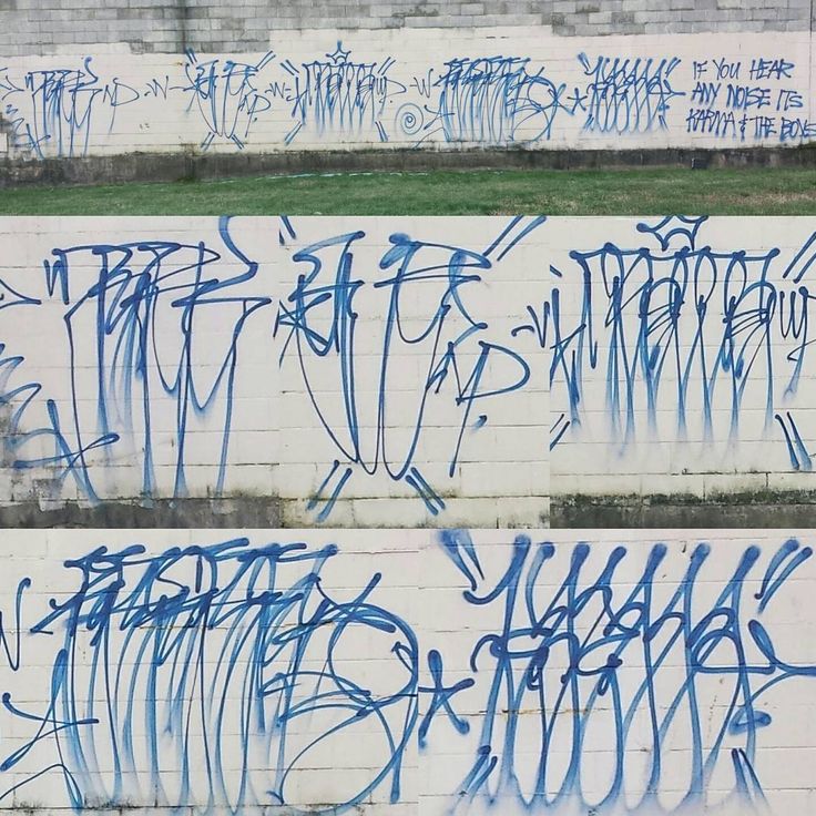 graffiti written on the side of a building in three different stages, blue and white