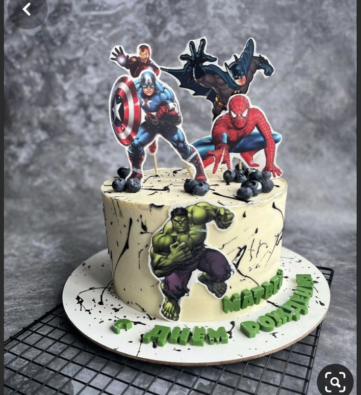 a cake decorated with the avengers and spider - man characters