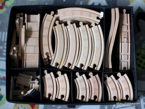 several wooden train tracks in a black box