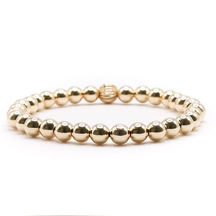 Introducing our 6mm Gold Ball, a must-have accessory for anyone looking to elevate their style. This stunning piece is perfect for gifting or treating yourself, with its warm and luxurious glow from the gold balls. It can be worn on its own or added to a stack of bracelets for a standout look. Whether it's a special occasion or just because, it's sure to impress and become a beloved staple in any collection. Luxury Gold Beaded Bracelets With Round Beads, Classic Gold Stretch Bracelet For Gifts, Classic Gold Stretch Bracelet As Gift, Classic Gold Stretch Bracelet Gift, Gold Beaded Bracelets With Round Beads For Meditation, Classic Gold Beads Stretch Bracelet Gift, Classic Gold Beads Stretch Bracelet As Gift, Classic Gold Stretch Bracelet With 8mm Beads, Classic Gold Beads Stretch Bracelet For Gift