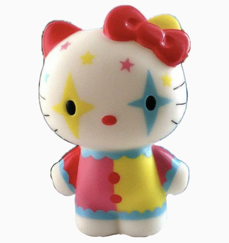 a hello kitty figurine with a red bow on its head and yellow dress