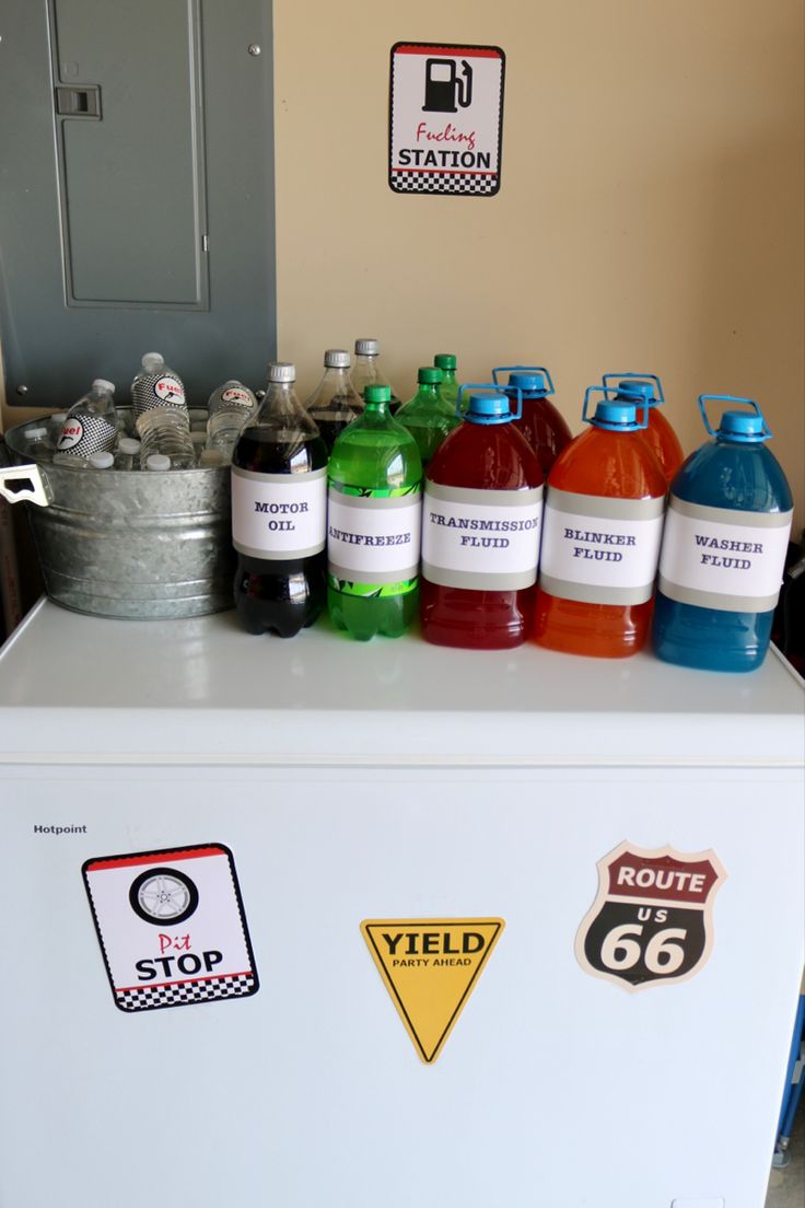 a refrigerator with many different types of soda bottles on it's top and side