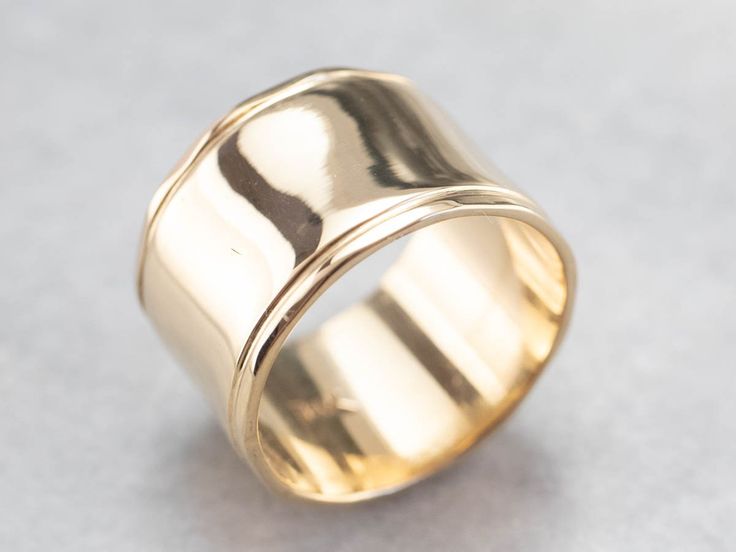 This vintage yellow gold band is absolutely stunning! Also called a cigar band, this ring has a high polish and beautiful shine. The yellow gold has a rich warmth to it that makes the ring all the more eye-catching. Metal: 14K Yellow Gold Width of Band: 12.1 mm Height off Finger: 1.0 mm Ring Size: 6.25 Marks: "14K" Stamped on the inside band Elegant Wide Band In Yellow Gold, Formal Fine Jewelry Wide Band Ring With Open Band, Formal Fine Jewelry Wide Band Open Ring, Formal 14k Stamped Wide Band Ring, Formal Fine Jewelry Open Band Wide Ring, Timeless Yellow Gold Wide Band Ring, Classic Gold Concave Wide Band Ring, Wide Band Yellow Gold Fine Jewelry, Wide Band In Yellow Gold Fine Jewelry Style