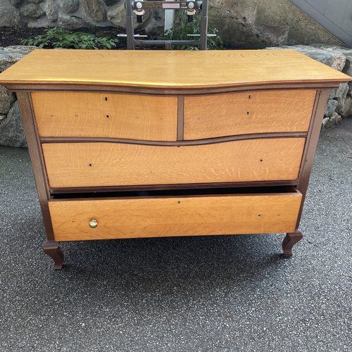 an old wooden dresser sitting in front of a stone wall