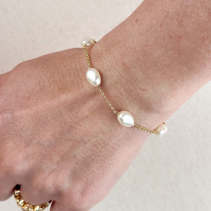 Indulge in the timeless beauty and sophistication of our 18k Gold Filled Spaced Baroque Pearl Bracelet. The perfect blend of elegance and delicacy, this classic piece exudes a luxurious charm that will elevate any outfit. Add a touch of opulence to your wardrobe and captivate with every turn of your wrist. Metal: 18k Gold Filled Width: 10mm Simulated Baroque Pearl Beads Size: 6.5 + 1 inch adjustment. Hypoallergenic Water-resistant Handcrafted in Brazil Elegant Rose Gold Plated Bracelets, Elegant Rose Gold-plated Bracelets, Elegant Bracelet Strap Jewelry For Formal Occasions, Elegant Wedding Pearl Chain Bracelet, Elegant Gold-plated Bangle Chain Bracelet, Adjustable Elegant Gold Bracelet, Timeless Gold Plated Bracelets For Formal Occasions, Timeless Gold Plated Bracelets For Formal Events, Timeless Gold Plated Bracelet For Formal Occasions