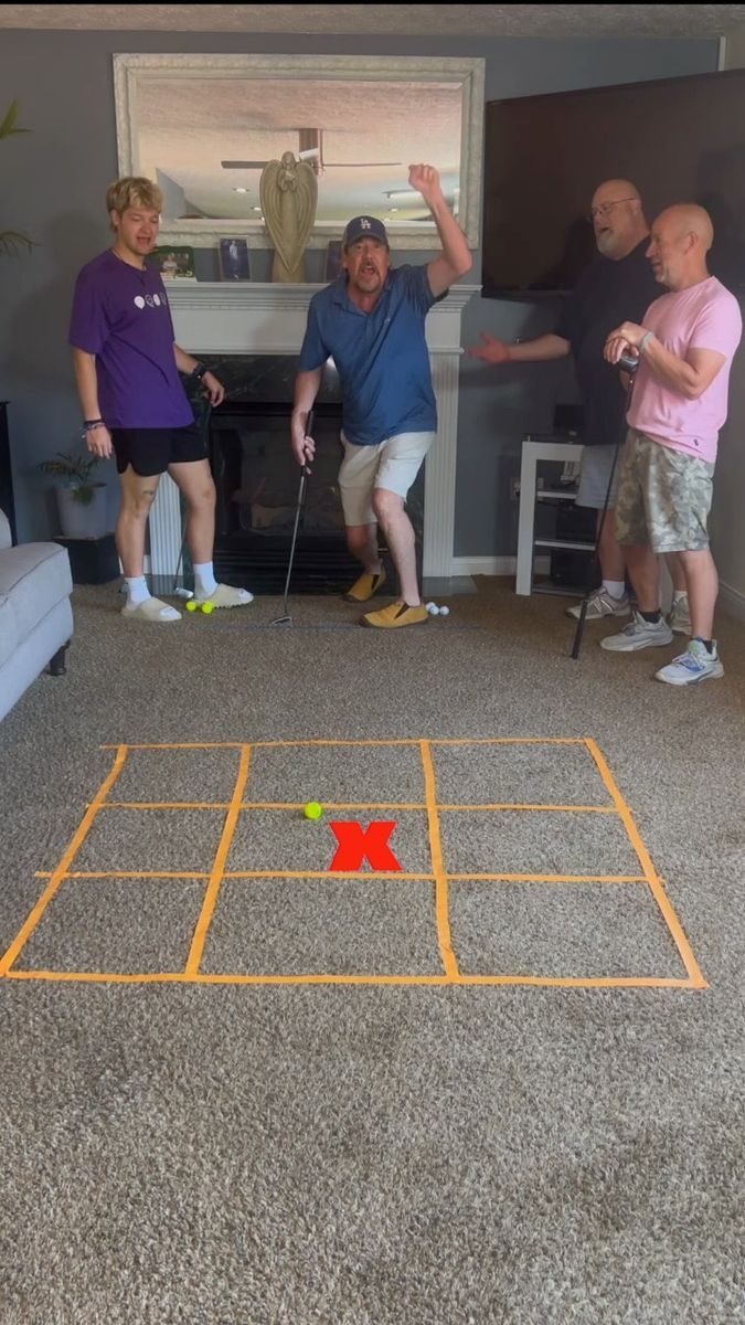 three people are playing a game on the floor