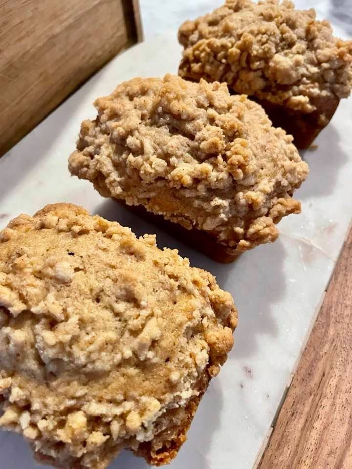 three oatmeal muffins sitting on top of a table