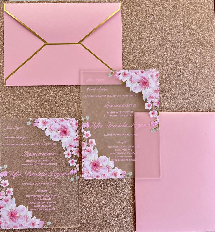 wedding stationery with pink flowers and gold trimmings on the front, back and inside