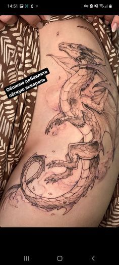 a woman's stomach with a dragon tattoo on the side and an image of a snake