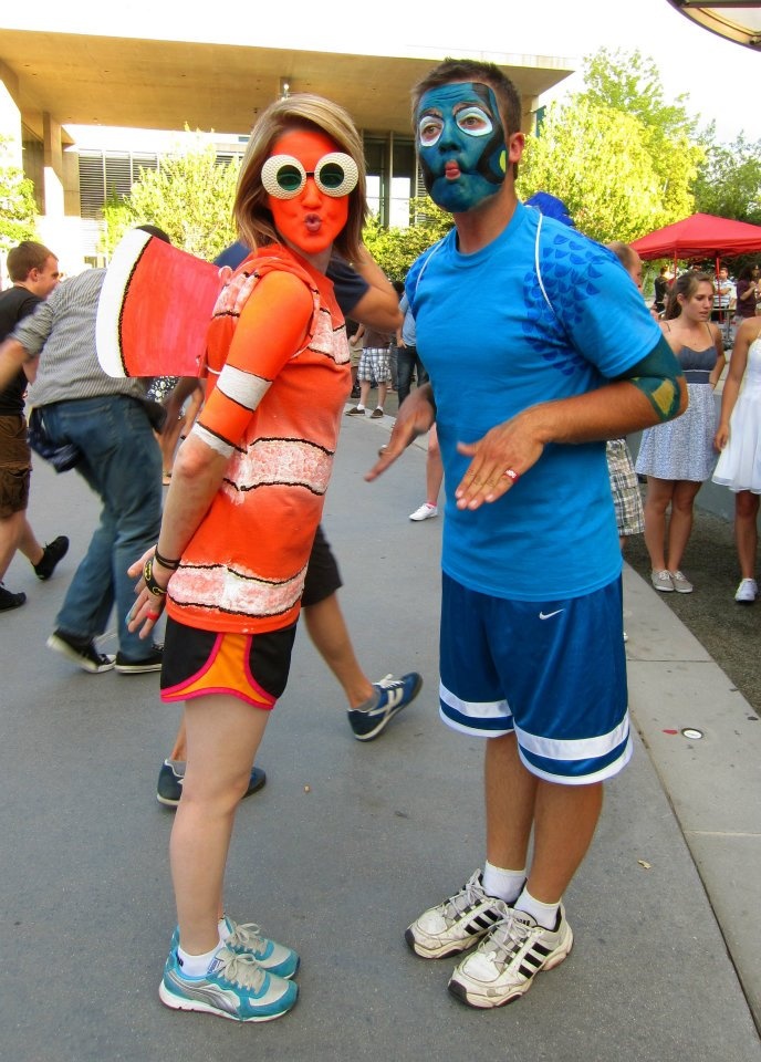 two people with face paint standing next to each other