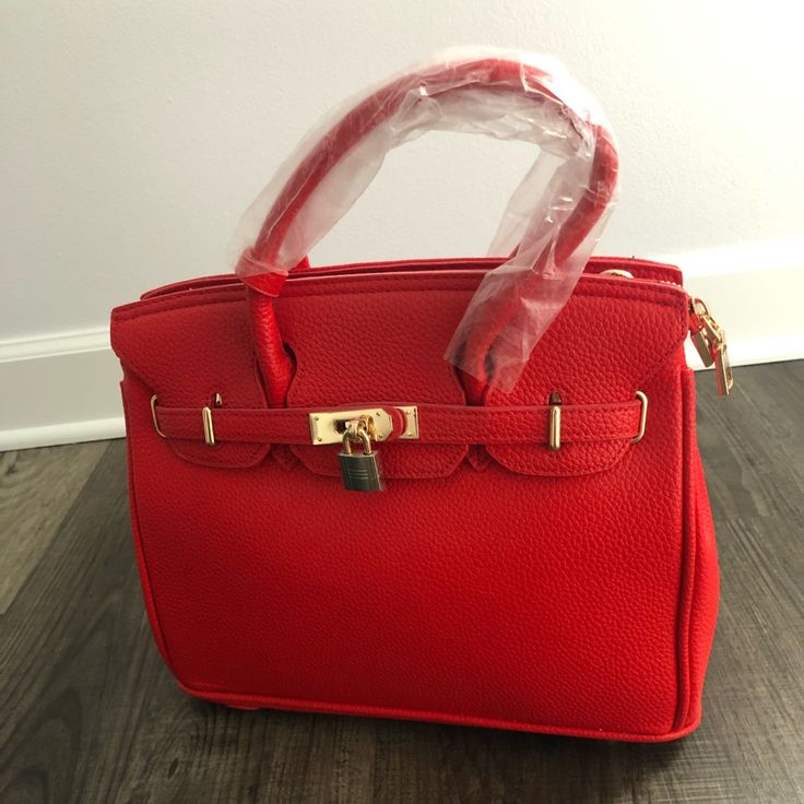 New Red Leather Women Handbag Never Used Red Box Bag With Detachable Strap For Travel, Red Tote Box Bag For Office, Trendy Red Box Bag With Double Handle, Red Top Handle Box Bag For Office, Luxury Red Bag With Hasp Closure, Red Shoulder Box Bag For Office, Red Satchel Box Bag For Office, Trendy Red Box Bag, Red Double Handle Box Bag For Shopping