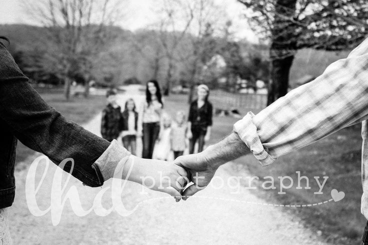 black and white photograph of people holding hands