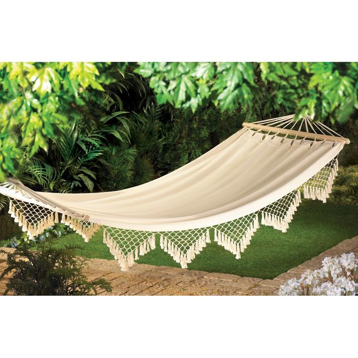 a white hammock hanging from a tree