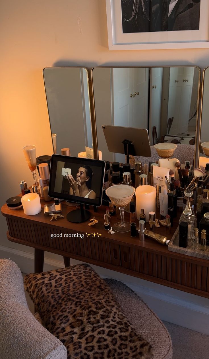 a vanity with candles and pictures on it