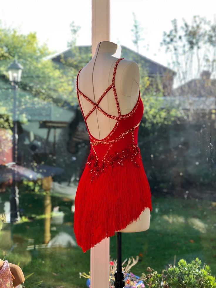 a red dress on display in front of a window