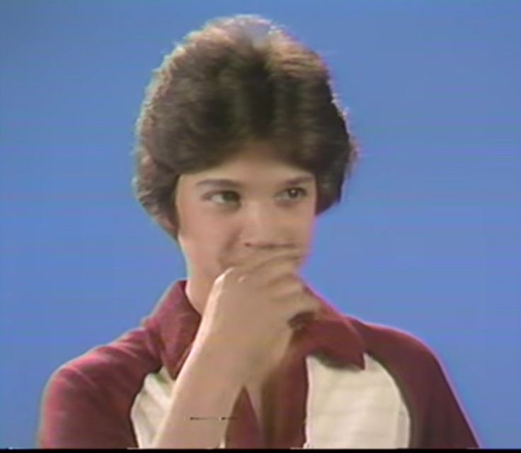 an old photo of a young boy with his hand on his chin