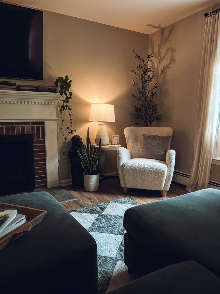 a living room filled with furniture and a flat screen tv mounted on the wall above a fireplace