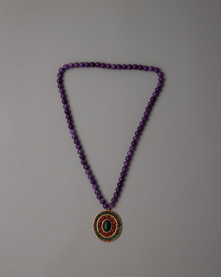 Amethyst Beads Necklace About our Locket: The Amethyst Beads Necklace is a stunning combination of spirituality and beauty. The deep purple color of each expertly made amethyst bead represents inner serenity and spiritual enlightenment. The locket is a remarkable focal point that is further emphasized by the fine inlay work of original jade and red onyx stones. It is crafted from copper and plated with electro gold. This combination gives the necklace a sense of spiritual energy and harmony in a Dharma Wheel, Rituals Set, Hanging Bell, Offering Bowls, Maitreya Buddha, Deep Purple Color, Wheel Of Life, Spiritual Energy, Spiritual Enlightenment