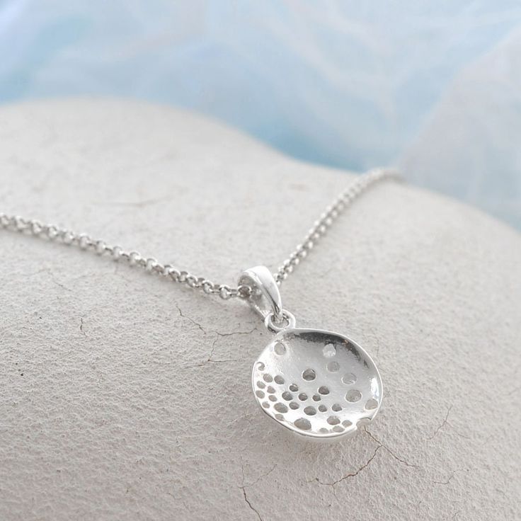 Our Wonderful Sterling Silver Bubble Dish Necklace uses a beautiful abstract design to create a truly interesting piece of jewellery . This gorgeous sterling silver necklace is perfect for people who like their jewellery with extra design and flare. This necklace can be made even more personal by the addition of some initial letter charms or a key and pearl combination. Why not complete the set with our matching sterling silver swirling waves earrings. All Martha Jackson jewellery comes complete with a gift box and blank gift card for you to write a short message on  Made from: Sterling silver Dimensions Pendant/earring diameter 1.9cm available on either a 40-45cm, 50cm or 61cm belcher chain. Add on key charm 1.3x0.5cm. Letter charms vary in size from 1cm to 1.5cm long. Unique Silver Drop Necklaces, Unique Silver Drop Necklace, Sterling Silver Drop Necklace With Large Pendant, Nickel-free Drop Sterling Silver Necklace, Sterling Silver Drop Necklace Nickel Free, Sterling Silver Hallmarked Round Pendant Necklace, Modern Sterling Silver Necklace In Silver, Drop White Gold Sterling Silver Necklaces, Sterling Silver Drop Necklaces