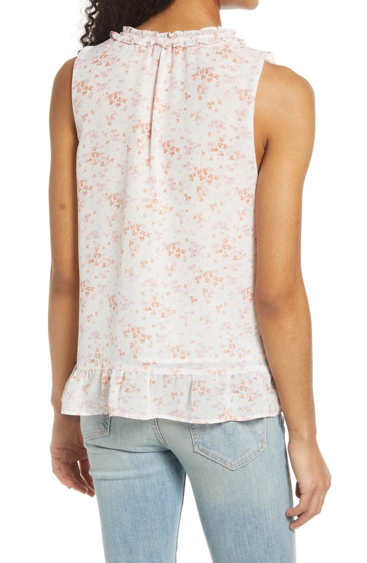 The charm is the pretty point of this dreamy little blouse sweetly tied at the neck and finished with a flounce at the hem. 24 1/2" length Split neck with ties Sleeveless 100% polyester Hand wash, dry flat Imported Feminine Flowy Top With Ruffle Hem, Flowy Feminine Top With Ruffle Hem, Feminine Floral Print Tops With Ruffled Collar, Feminine Tops With Floral Print And Ruffled Collar, Feminine Blouse With Floral Print And Ruffled Collar, White Tops With Floral Print And Ruffled Collar, Feminine Blouse With Ruffle Hem And Ruffled Collar, Feminine Flowy Blouse With Ruffles, Feminine Ruffle Hem Blouse For Daywear