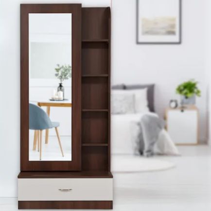 a mirror sitting on top of a wooden shelf next to a dresser and chair in a room