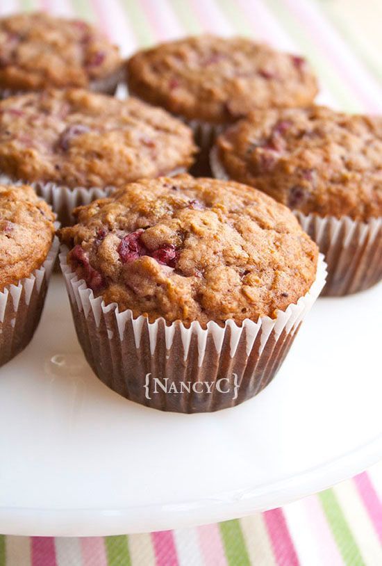 several muffins sitting on top of a white plate covered in cranberry topping