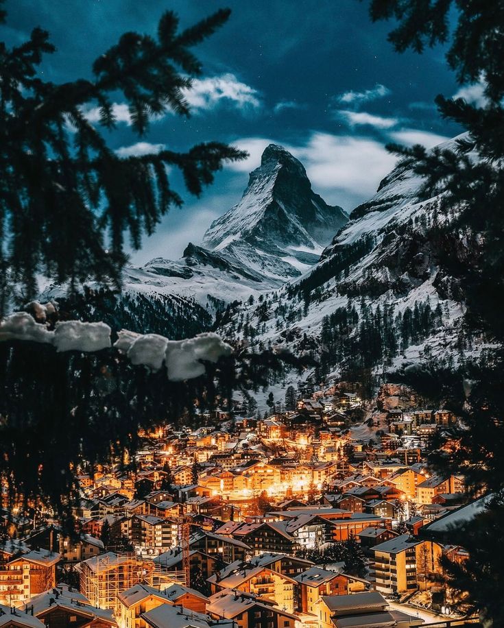 a snowy mountain town lit up at night