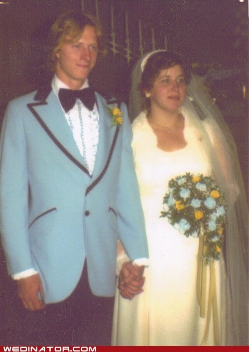 a man and woman in wedding attire standing next to each other with flowers on their lapels