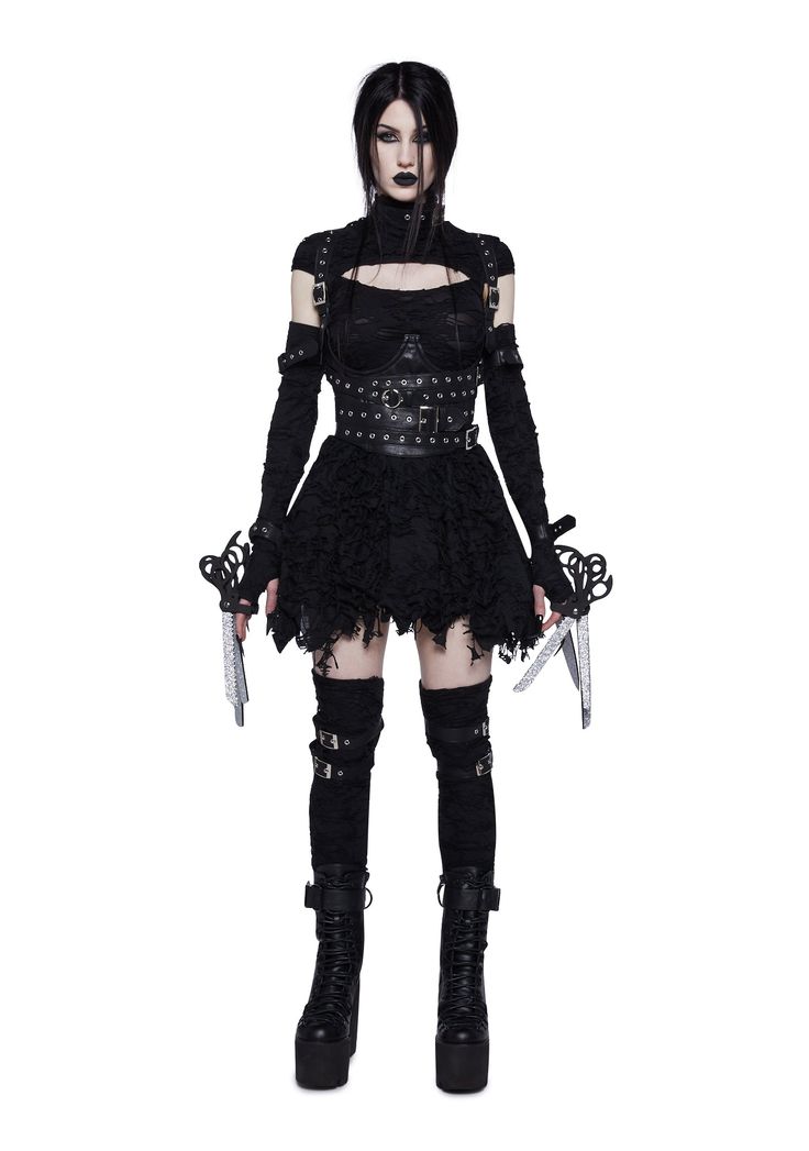 a woman dressed in black holding two knives