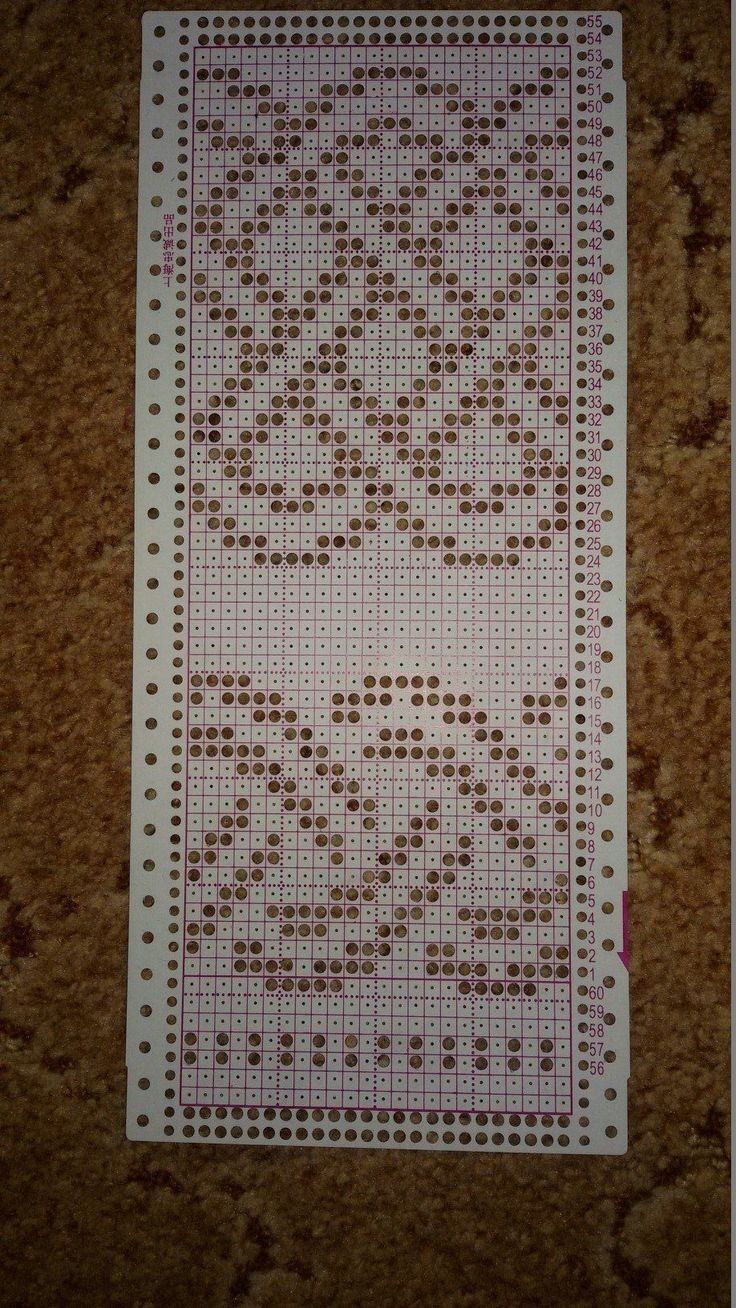 a cross - stitch pattern on the floor with brown and white dots in it's center