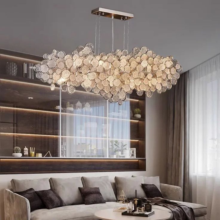 a living room filled with furniture and a large chandelier hanging from the ceiling