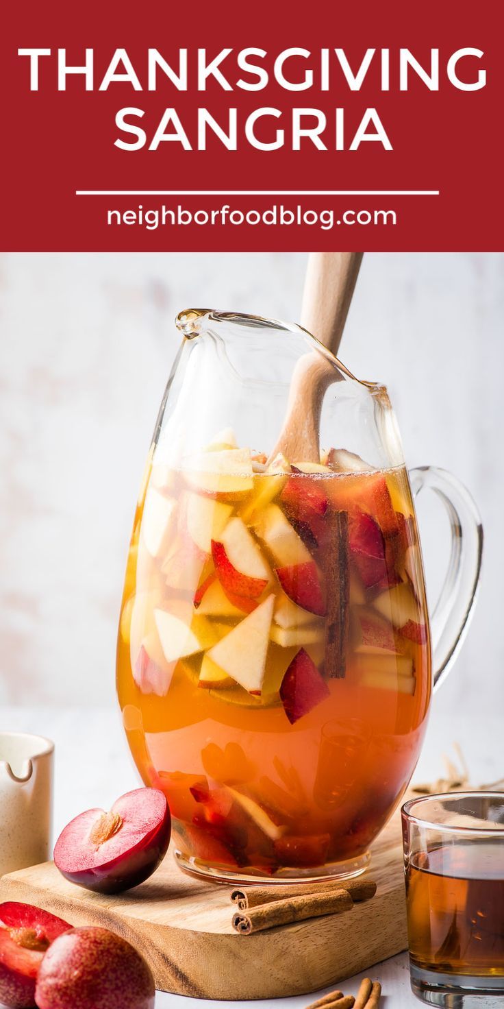 a pitcher filled with apple cider and sliced apples