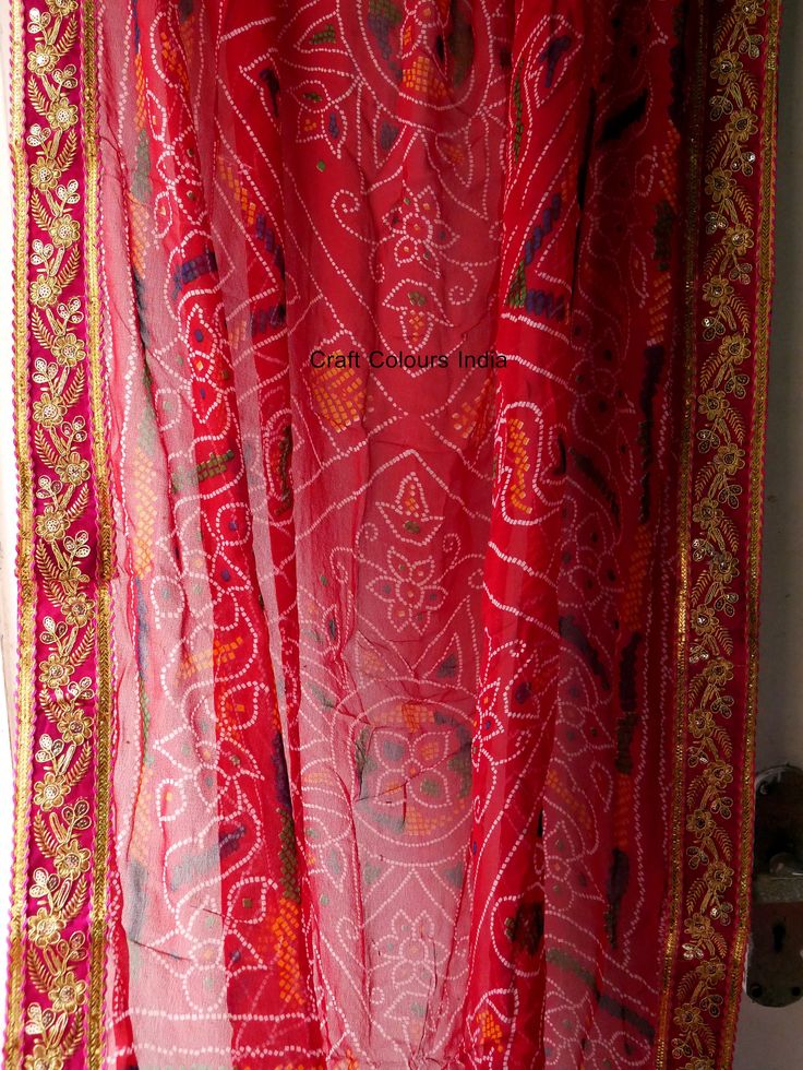 Very beautiful and gorgeous light weight red Georgette tie dye bandhej chunri with zari work. It is decorated with golden flower embroidered lace on all 4 sides. This is a ready to wear dupatta/scarf. It can be used for wedding, wedding rituals, party, bridesmaid gift, lehenga dupatta, Indian functions or events. Dimension: Length: 2 meter Width: 1.2 meter Rajasthani Dupatta, Golden Dupatta, Shoulder Scarf, Eid Photoshoot Ideas, Lehenga Dupatta, Embroidery Border, Modern Christmas Decor, Wedding Rituals, Golden Flower