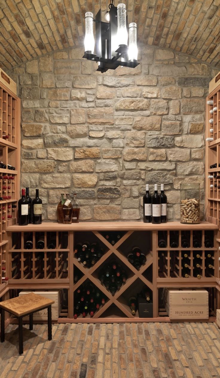 a wine cellar with several bottles on the shelves