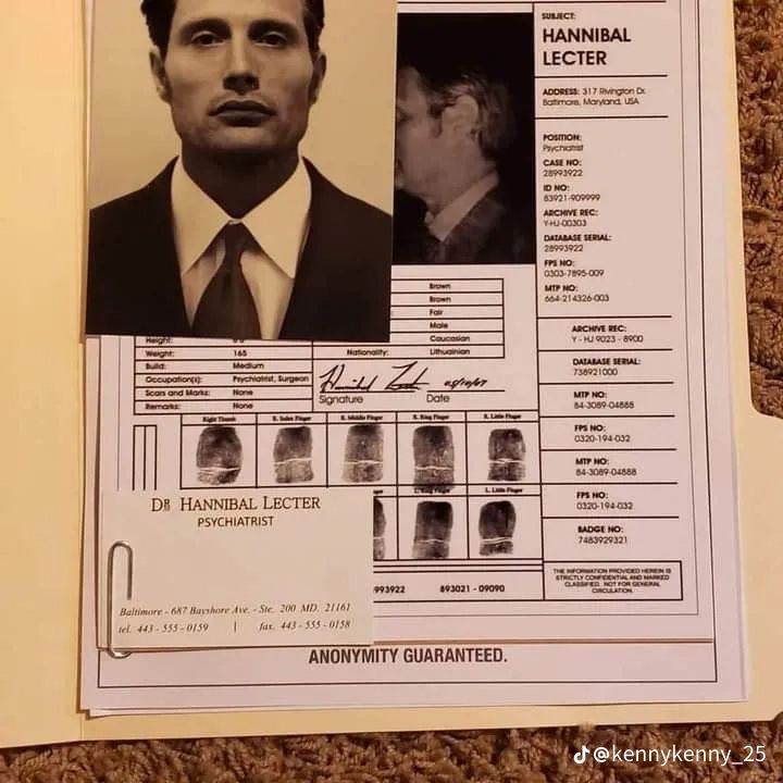 an identification sheet with a photo of a man in a suit and tie on it