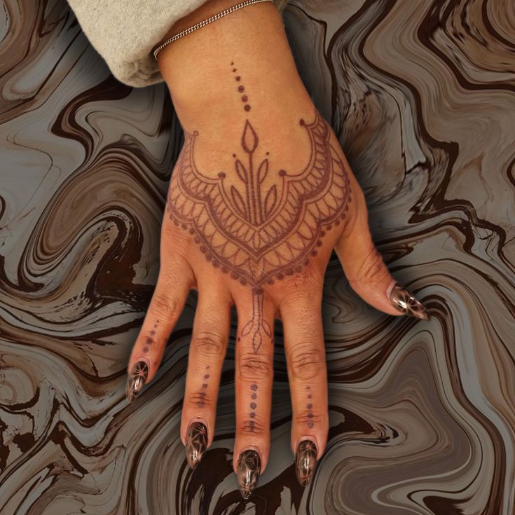 a woman's hand with an intricate design on it