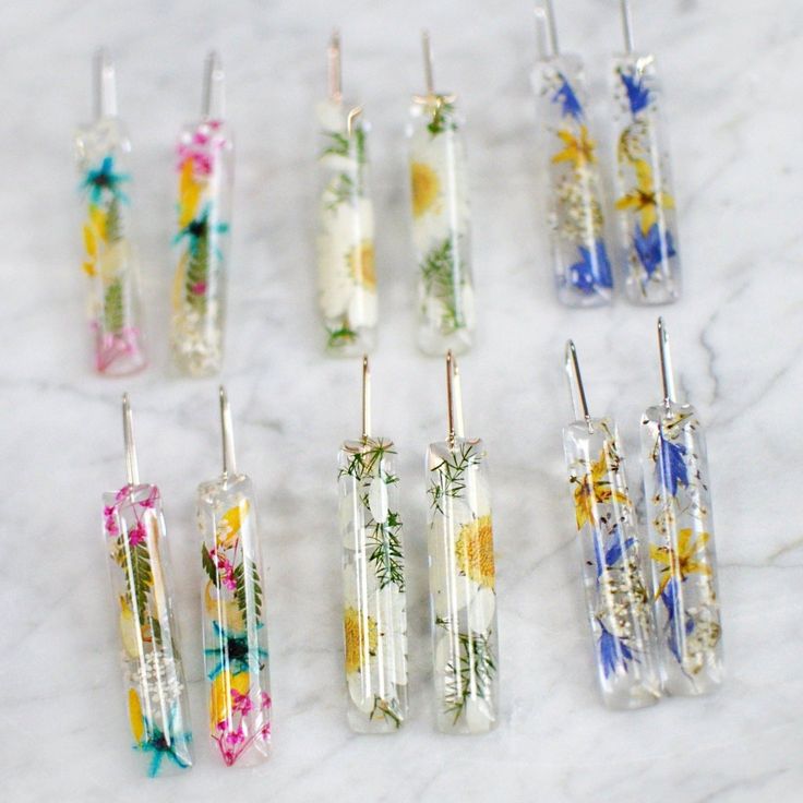 six different colored toothbrushes sitting on top of a marble counter